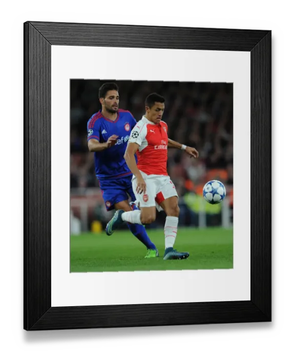 Framed Print : Clash of Stars: Alexis Sanchez vs. Alberto Botia in Arsenal's Champions League Battle against Olympiacos Framed Print : Clash of Stars: Alexis Sanchez vs. Alberto Botia in Arsenal's Champions League Battle against Olympiacos