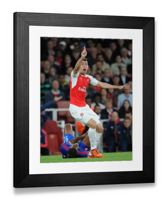 Framed Print : Gabriel's Defiant Clash: Arsenal vs Olympiacos in the 2015 / 16 UEFA Champions League