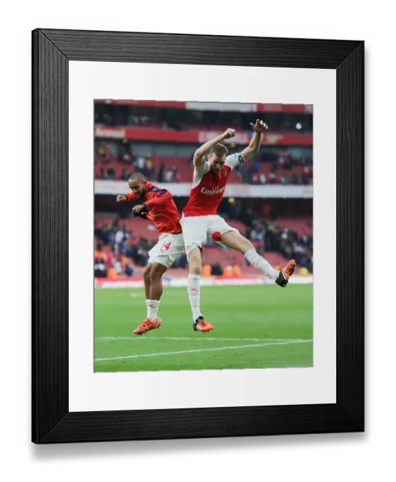 Framed Print : Arsenal's Glory: Theo Walcott and Per Mertesacker Celebrate Hard-Fought Victory Over Manchester United (2015 / 16 Premier League)