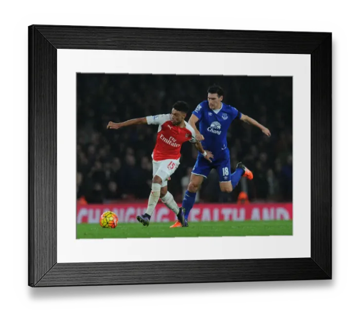 Framed Print : Oxlade-Chamberlain vs Barry: Intense Battle in Arsenal vs Everton Premier League Clash Framed Print : Oxlade-Chamberlain vs Barry: Intense Battle in Arsenal vs Everton Premier League Clash