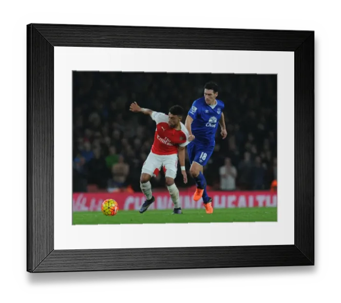 Framed Print : Oxlade-Chamberlain vs. Barry: A Premier League Showdown at Emirates Stadium Framed Print : Oxlade-Chamberlain vs. Barry: A Premier League Showdown at Emirates Stadium