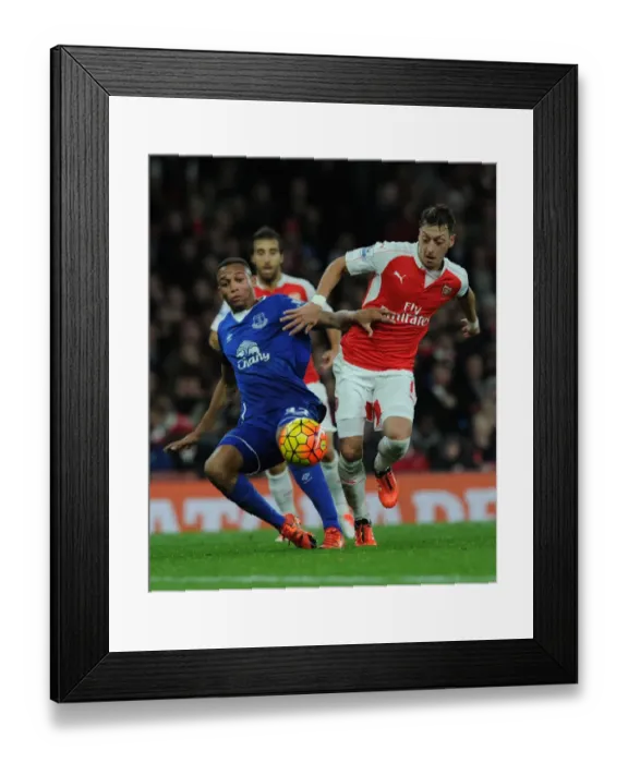 Framed Print : Ozil vs. Galloway: A Premier League Showdown at Emirates Stadium