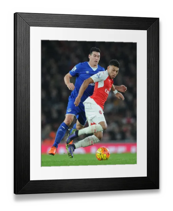 Framed Print : Arsenal's Oxlade-Chamberlain vs. Everton's Barry: Intense Clash in Premier League Showdown Framed Print : Arsenal's Oxlade-Chamberlain vs. Everton's Barry: Intense Clash in Premier League Showdown