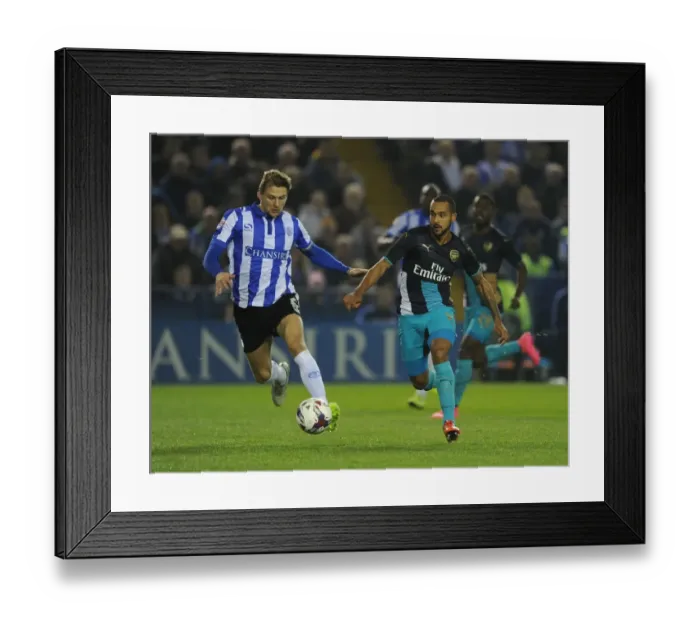 Framed Print : Theo Walcott vs. Glenn Loovens: A Battle of Wits in the Sheffield Wednesday vs. Arsenal Capital One Cup Clash
