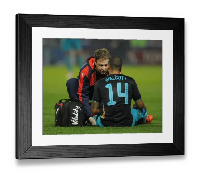 Framed Print : Arsenal's Theo Walcott Receives Treatment During Sheffield Wednesday vs Arsenal - Capital One Cup 2015-16