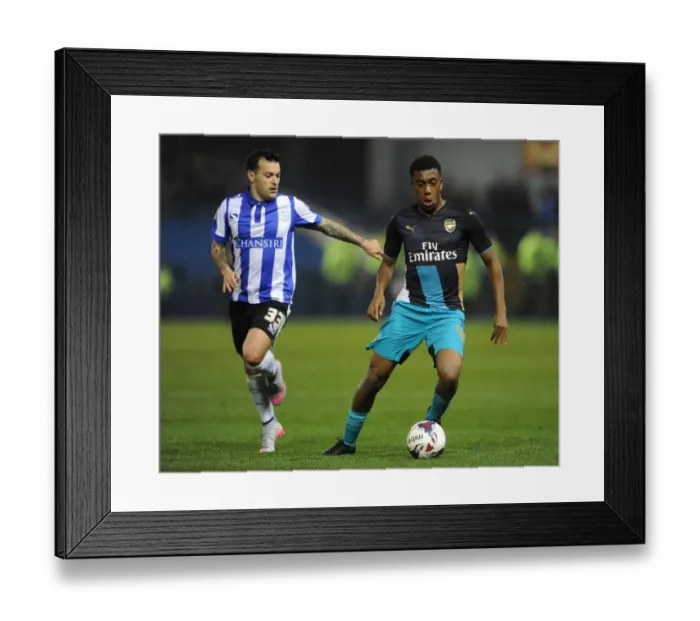 Framed Print : Alex Iwobi vs. Ross Wallace: A Fierce Face-Off in the Capital One Cup Clash Between Arsenal and Sheffield Wednesday