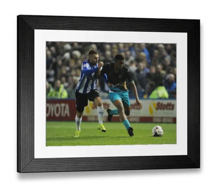 Framed Print : Arsenal's Alex Iwobi Goes Head-to-Head with Sheffield Wednesday's Jack Hunt in Capital One Cup Clash