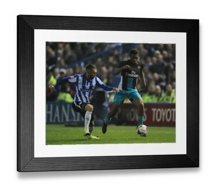 Framed Print : Arsenal's Alex Iwobi Clashes with Jack Hunt in Capital One Cup Battle Framed Print : Arsenal's Alex Iwobi Clashes with Jack Hunt in Capital One Cup Battle