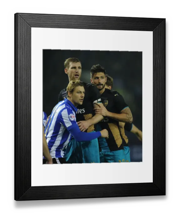Framed Print : Per Mertesacker and Olivier Giroud vs. Glenn Loovens: A Capital One Cup Showdown