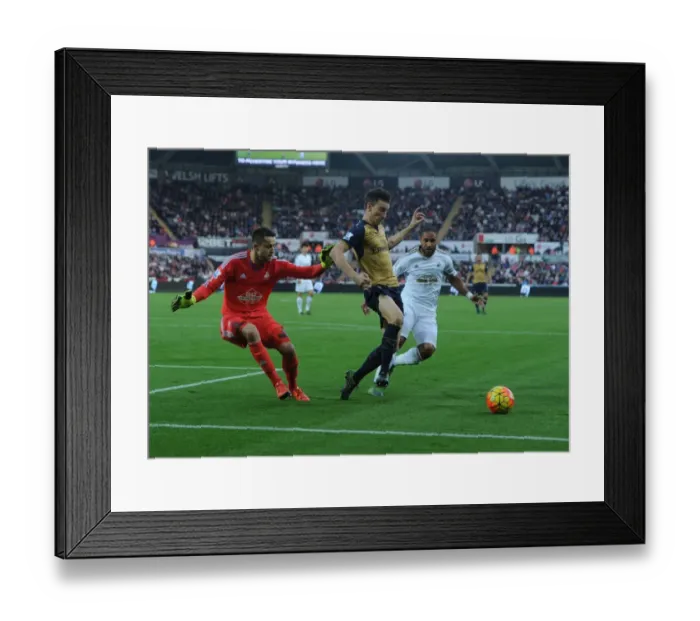 Framed Print : Arsenal's Koscielny Faces Off Against Swansea's Fabianski and Williams (2015-16) Framed Print : Arsenal's Koscielny Faces Off Against Swansea's Fabianski and Williams (2015-16)