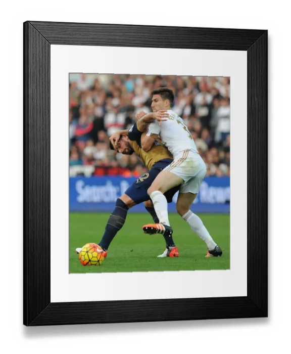 Framed Print : Giroud vs Fernandez: A Football Showdown at Liberty Stadium - Swansea City vs Arsenal, 2015-16 Premier League