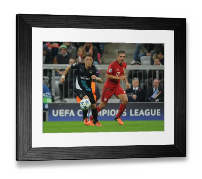 Framed Print : Mesut Ozil vs. Philipp Lahm: A Champions League Showdown