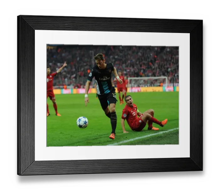 Framed Print : Mesut Ozil Outmaneuvers Phillip Lahm: A UEFA Champions League Showdown