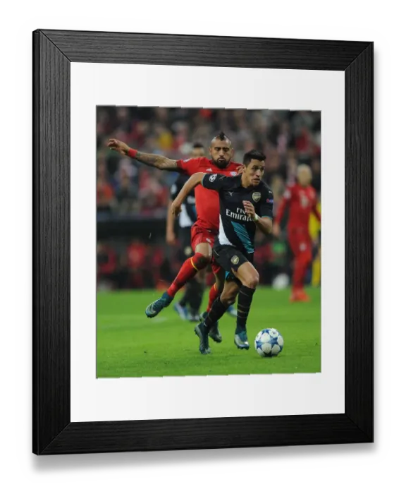 Framed Print : Sanchez vs. Vidal: A Champions League Showdown - Arsenal's Star Forward Clashes with Bayern's Midfield Maestro Framed Print : Sanchez vs. Vidal: A Champions League Showdown - Arsenal's Star Forward Clashes with Bayern's Midfield Maestro