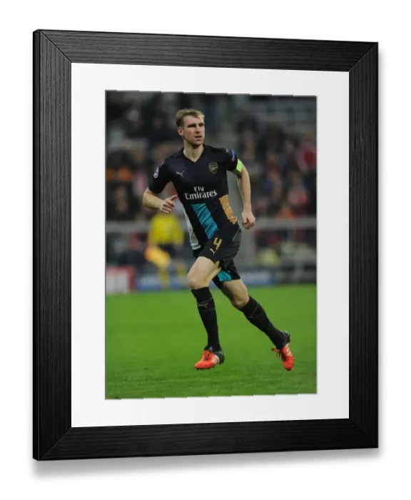 Framed Print : Champions Clash: Bayern Munich vs. Arsenal - UEFA Champions League, 2015: Per Mertesacker of Arsenal in Action at Allianz Arena