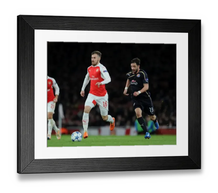 Framed Print : Arsenal's Aaron Ramsey Outruns Goncalo Santos: A Moment of Speed and Skill in the 2015-16 Champions League Clash Framed Print : Arsenal's Aaron Ramsey Outruns Goncalo Santos: A Moment of Speed and Skill in the 2015-16 Champions League Clash