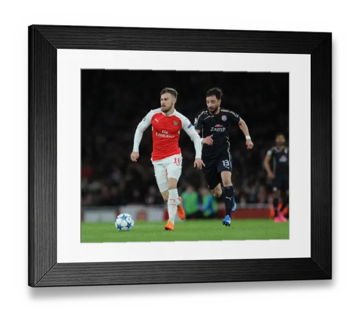 Framed Print : Arsenal's Aaron Ramsey Outsmarts Goncalo Santos in Champs League Showdown Framed Print : Arsenal's Aaron Ramsey Outsmarts Goncalo Santos in Champs League Showdown