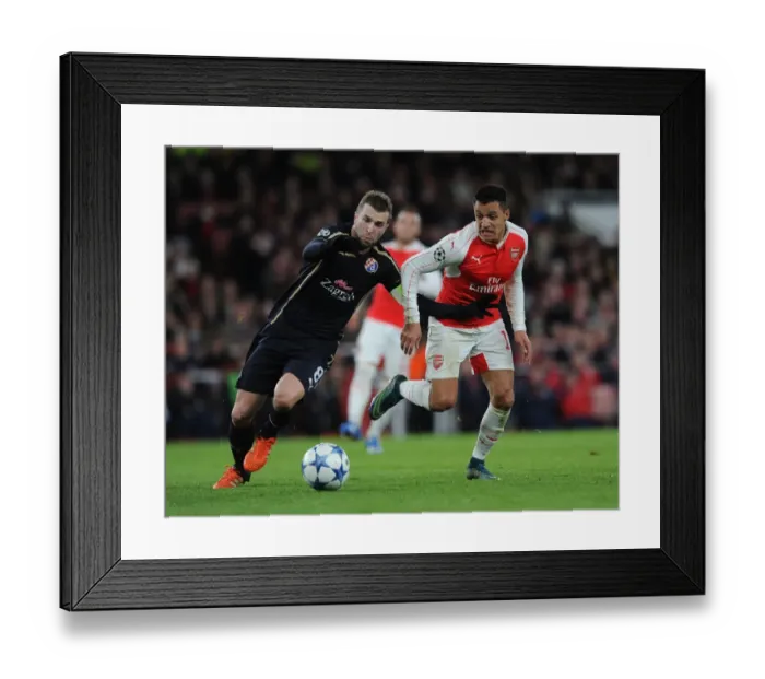 Framed Print : Alexis Sanchez vs. Domagoj Antolic: A Battle in the Arsenal vs. Dinamo Zagreb UEFA Champions League Clash Framed Print : Alexis Sanchez vs. Domagoj Antolic: A Battle in the Arsenal vs. Dinamo Zagreb UEFA Champions League Clash