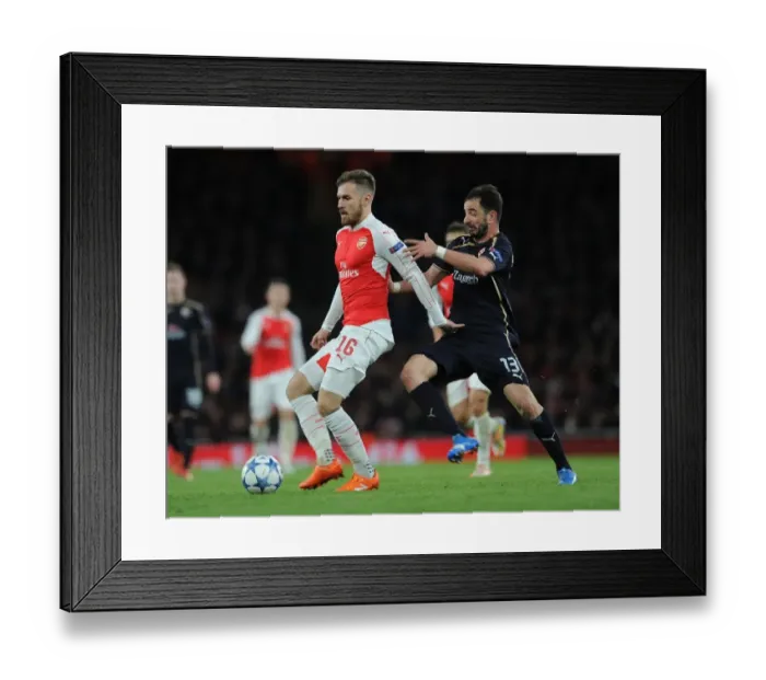 Framed Print : Arsenal's Aaron Ramsey Outruns Goncalo Santos: Thrilling Champions League Showdown Framed Print : Arsenal's Aaron Ramsey Outruns Goncalo Santos: Thrilling Champions League Showdown