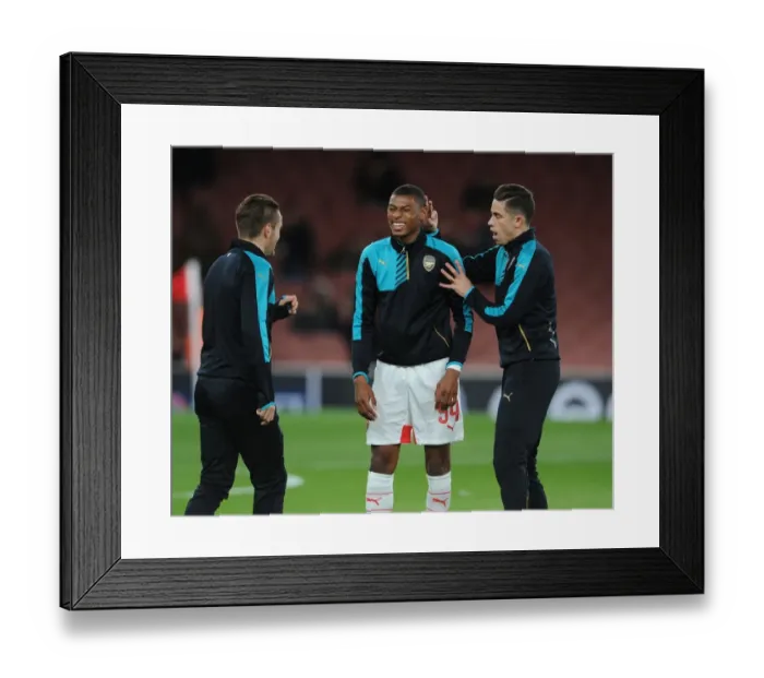 Framed Print : Arsenal Players Jeff Reine-Adelaide and Gabriel Share a Light-Hearted Moment During Champions League Warm-Up