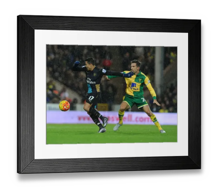 Framed Print : Arsenal's Alexis Sanchez Battles Norwich's Gary O'Neil in Intense Premier League Showdown