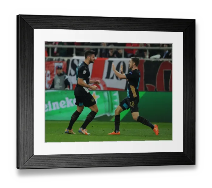 Framed Print : Arsenal's Olivier Giroud and Aaron Ramsey Celebrate First Goal in UEFA Champions League Match Against Olympiacos Framed Print : Arsenal's Olivier Giroud and Aaron Ramsey Celebrate First Goal in UEFA Champions League Match Against Olympiacos