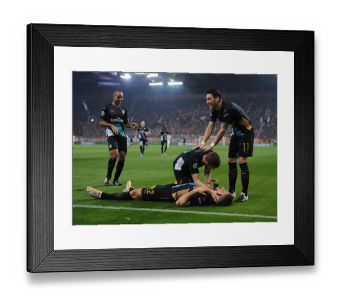 Framed Print : Arsenal's Star Players: Giroud, Ramsey, Ozil, and Walcott Celebrate Goals Against Olympiacos in the UEFA Champions League