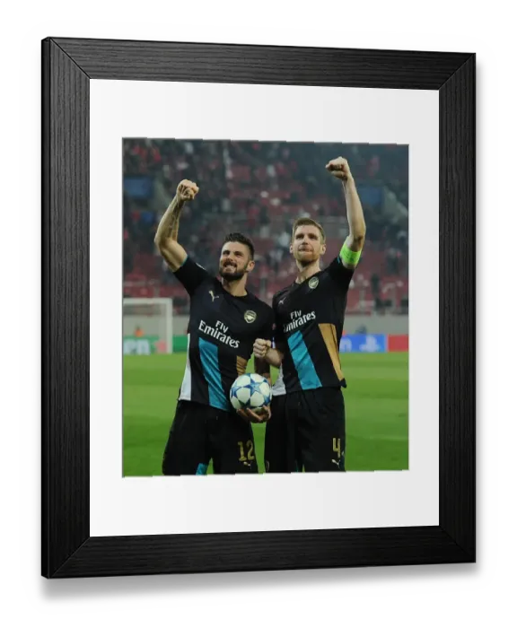 Framed Print : Unforgettable Celebration: Giroud and Mertesacker's Victory Moment at Olympiacos vs. Arsenal, UEFA Champions League (December 2015) Framed Print : Unforgettable Celebration: Giroud and Mertesacker's Victory Moment at Olympiacos vs. Arsenal, UEFA Champions League (December 2015)