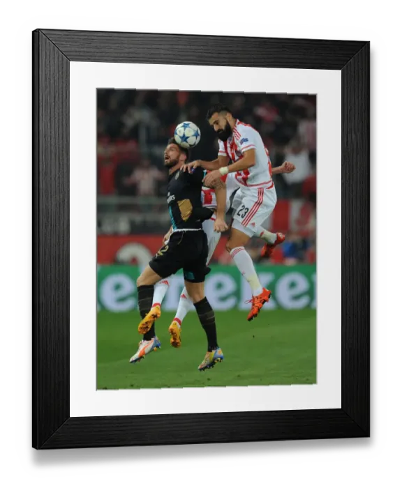 Framed Print : Clash in Athens: Olivier Giroud vs. Dimitris Siovas - Arsenal vs. Olympiacos, UEFA Champions League