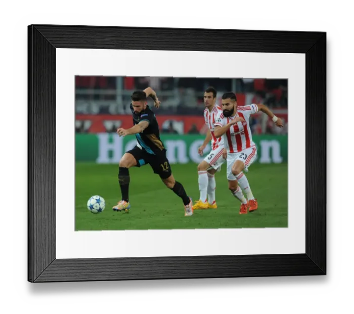 Framed Print : Olivier Giroud Overpowers Dimitris Siovas: Arsenal's Thrilling Victory over Olympiacos in the UEFA Champions League, Athens 2015