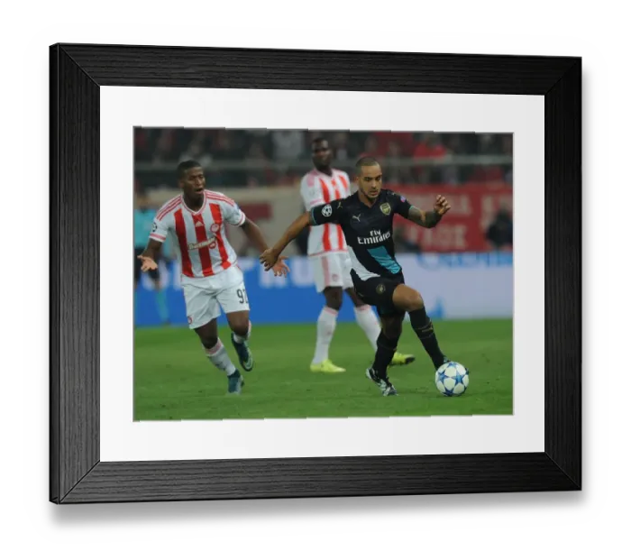 Framed Print : Theo Walcott Outmaneuvers Seba: A Champions League Showdown at Olympiacos (2015)