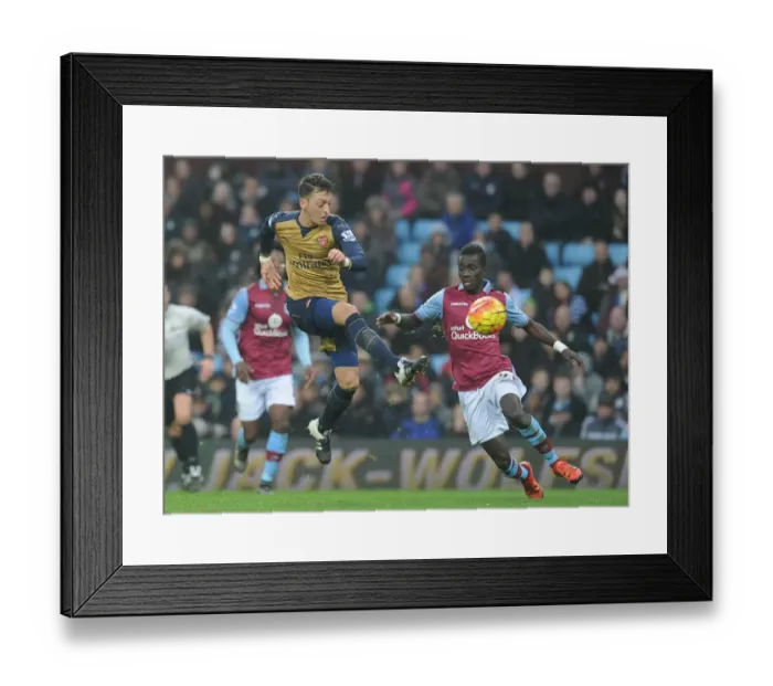 Framed Print : Mesut Ozil vs. Idrissa Gana: A Premier League Showdown at Villa Park