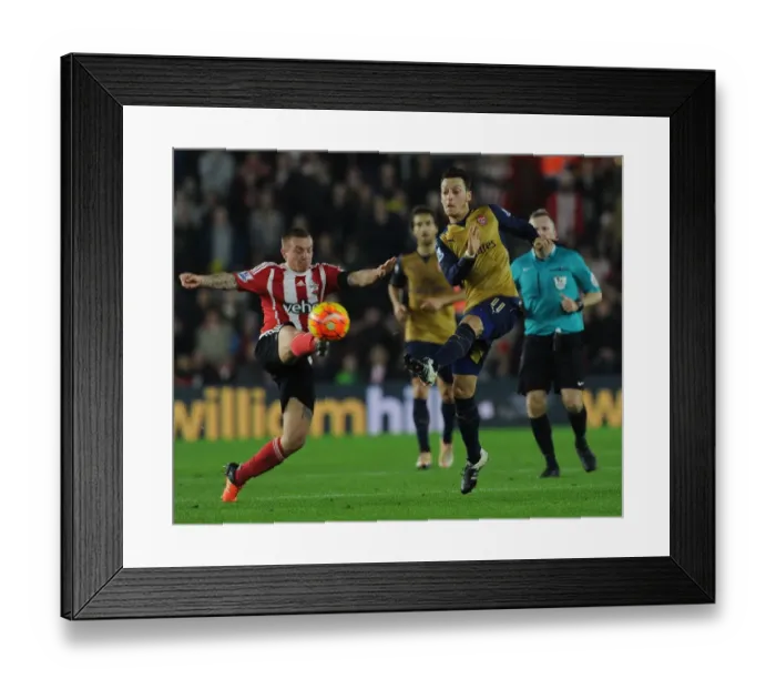 Framed Print : Mesut Ozil vs Jordy Clasie: A Premier League Showdown at Southampton's St Marys Stadium - Arsenal vs Southampton (2015-16)