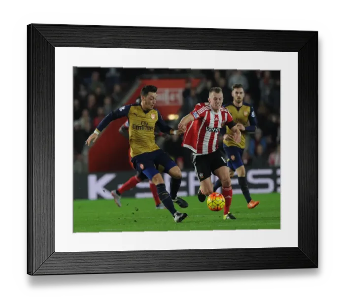 Framed Print : Mesut Ozil Outsmarts James Ward-Prowse: Arsenal Star's Agile Move in Southampton Clash