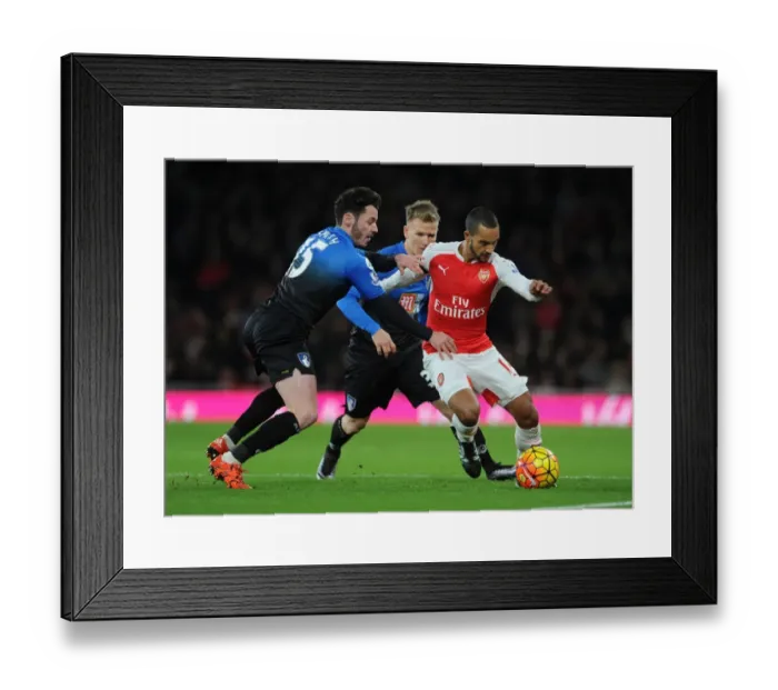 Framed Print : Arsenal vs Bournemouth: Theo Walcott's Intense Face-Off Against Smith and Ritchie (December 2015)