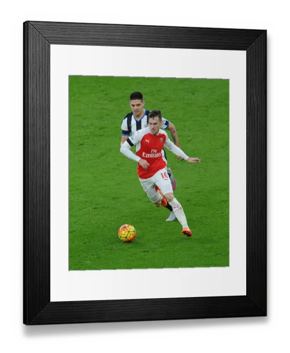 Framed Print : Ramsey vs Mitrovic: Intense Clash between Arsenal's Midfielder and Newcastle's Striker in Premier League Showdown