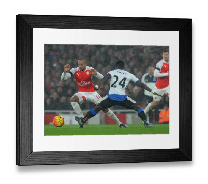 Framed Print : Theo Walcott vs. Cheick Tiote: A Fierce Battle in the Arsenal v Newcastle United Premier League Clash Framed Print : Theo Walcott vs. Cheick Tiote: A Fierce Battle in the Arsenal v Newcastle United Premier League Clash