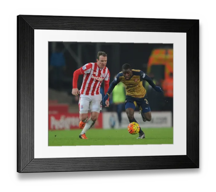 Framed Print : Joel Campbell's Slick Move: Outmaneuvering Glenn Whelan in the Stoke City vs. Arsenal Clash