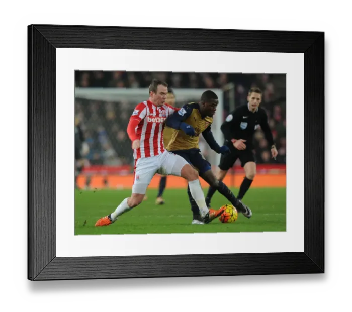Framed Print : Intense Battle: Joel Campbell vs Glenn Whelan at Stoke City vs Arsenal (2015-16)