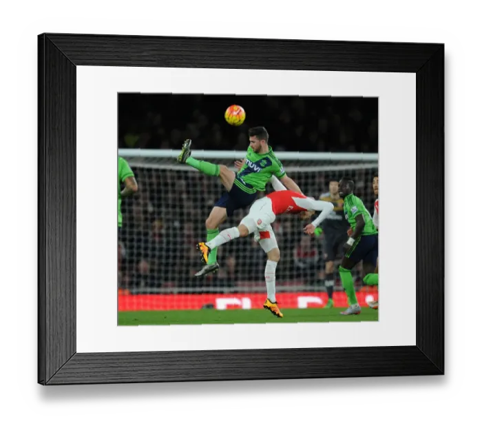 Framed Print : Arsenal vs. Southampton: A Battle Between Gabriel and Long at the Emirates Stadium