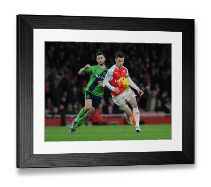 Framed Print : Clash at Emirates: Koscielny vs. Long - Arsenal vs. Southampton, Premier League 2015-16: A Battle Between Koscielny and Long at the Emirates Stadium Framed Print : Clash at Emirates: Koscielny vs. Long - Arsenal vs. Southampton, Premier League 2015-16: A Battle Between Koscielny and Long at the Emirates Stadium