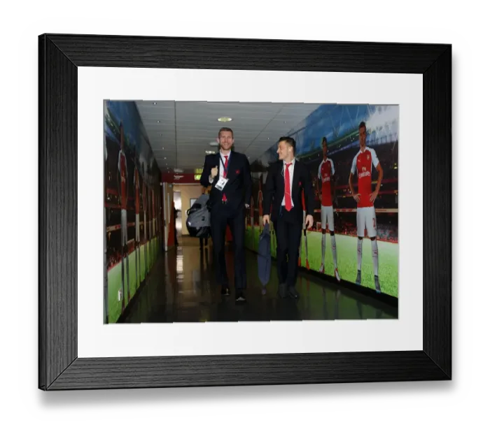 Framed Print : Arsenal FC: Per Mertesacker and Mesut Ozil Heading to the Changing Room before Arsenal vs. FC Barcelona - UEFA Champions League Round of 16, First Leg (2016)