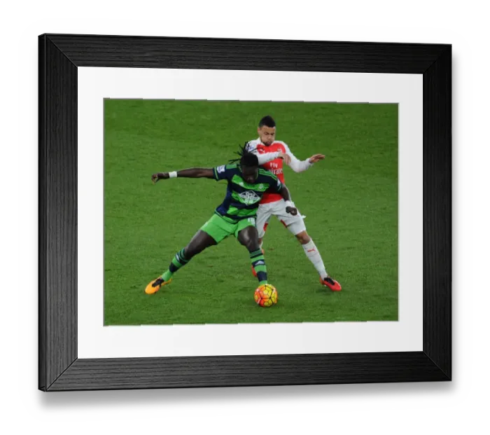 Framed Print : Coquelin vs Gomis: A Premier League Battle at Emirates Stadium - Arsenal vs Swansea City