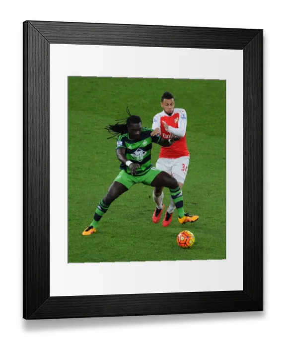Framed Print : Coquelin vs Gomis: Intense Battle in Arsenal's Premier League Clash Against Swansea City Framed Print : Coquelin vs Gomis: Intense Battle in Arsenal's Premier League Clash Against Swansea City