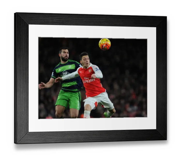 Framed Print : Mesut Ozil vs Jordi Amat: Intense Battle at the Emirates during Arsenal vs Swansea Clash (2015-16)