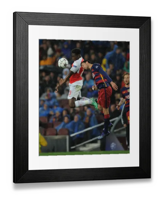 Framed Print : Aerial Showdown: Danny Welbeck vs. Sergio Busquets in the UEFA Champions League Battle between Arsenal and Barcelona