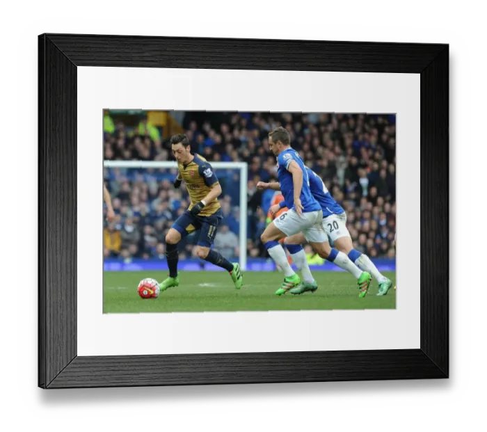 Framed Print : Mesut Ozil vs. Phil Jagielka: A Premier League Showdown at Goodison Park