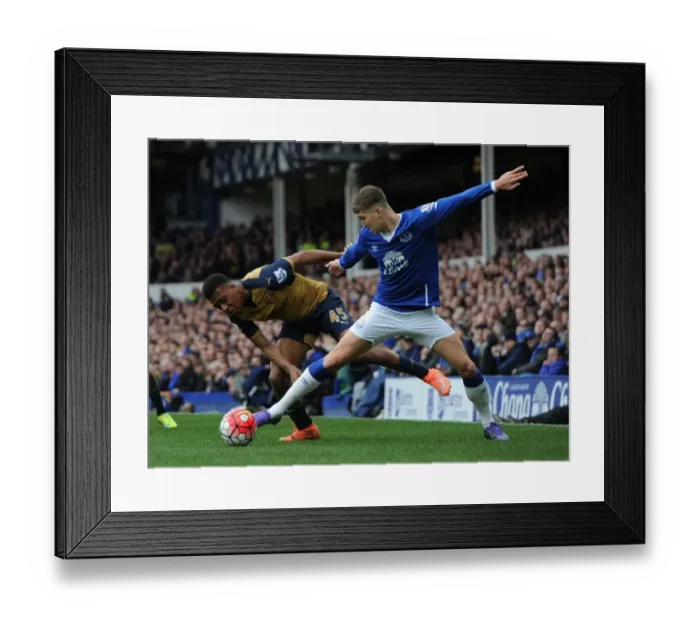Framed Print : Arsenal's Alex Iwobi vs Everton's John Stones: Intense Face-Off in Premier League Showdown Framed Print : Arsenal's Alex Iwobi vs Everton's John Stones: Intense Face-Off in Premier League Showdown