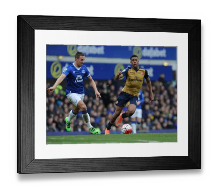 Framed Print : Arsenal's Alex Iwobi vs. Everton's Phil Jagielka: Intense Face-Off in Premier League Clash Framed Print : Arsenal's Alex Iwobi vs. Everton's Phil Jagielka: Intense Face-Off in Premier League Clash