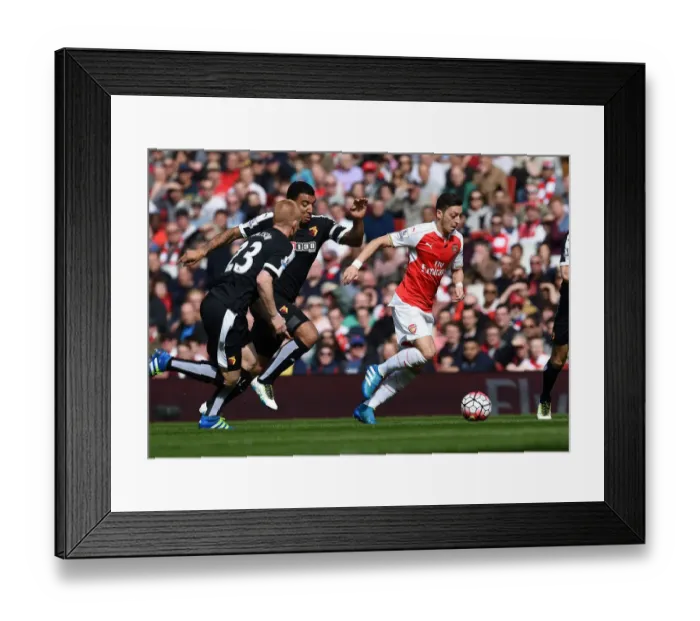 Framed Print : Mesut Ozil Slices Through Defenders: Arsenal's Triumph over Watford (April 2016) Framed Print : Mesut Ozil Slices Through Defenders: Arsenal's Triumph over Watford (April 2016)